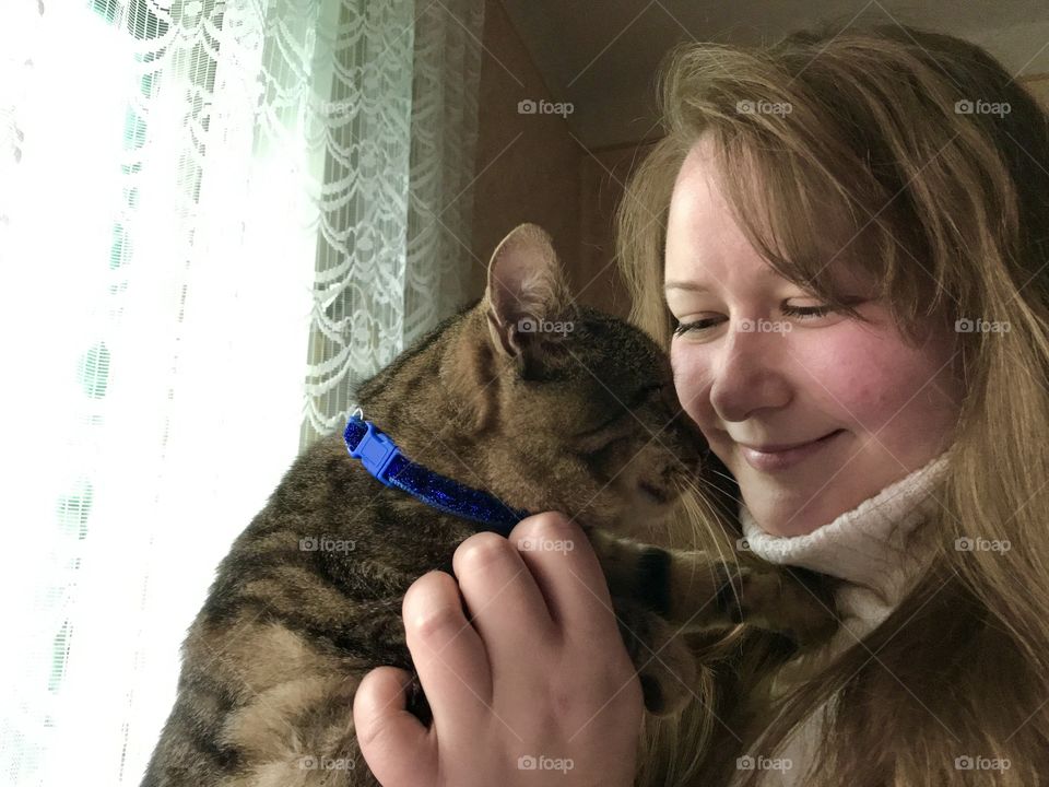A girl and a gray cat.