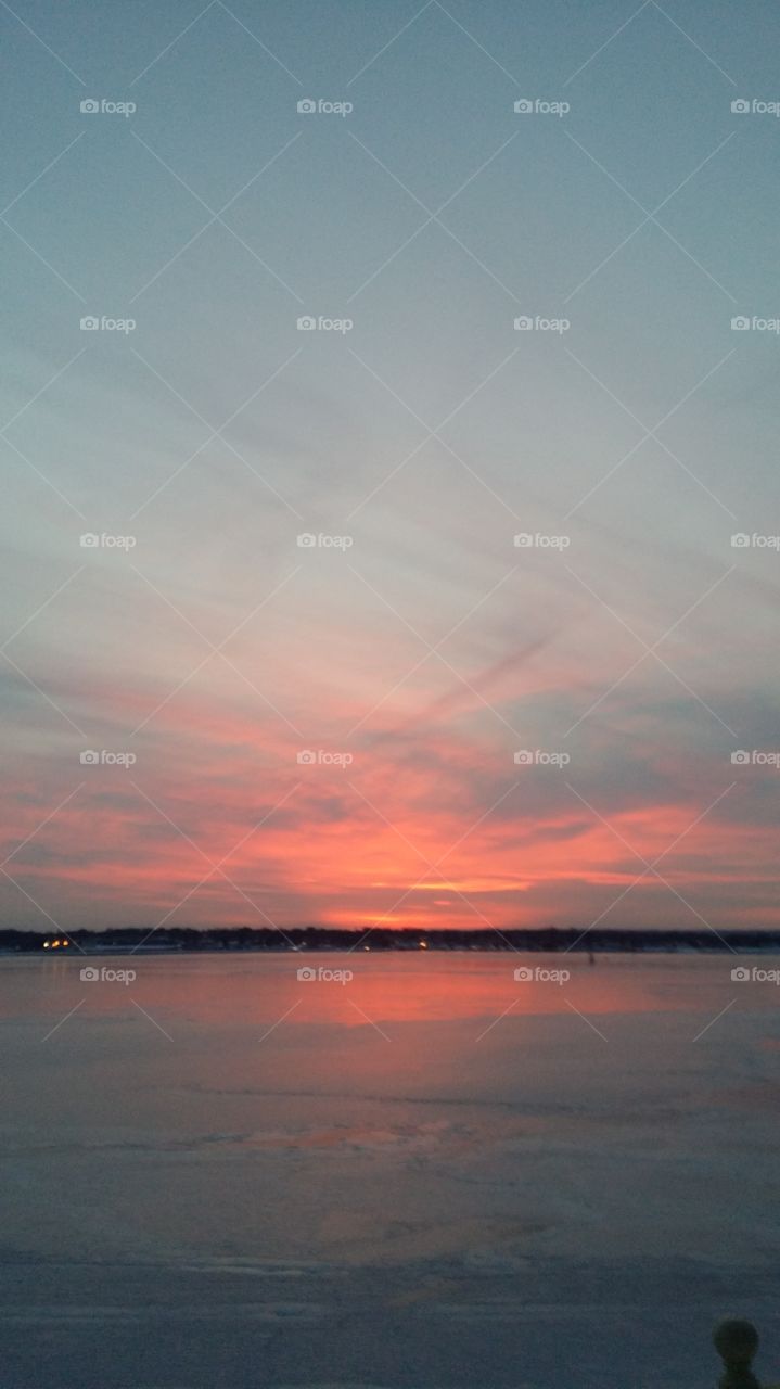 Frozen sunset by Noel. The reflections of the sky into the frozen Bay is magnificent