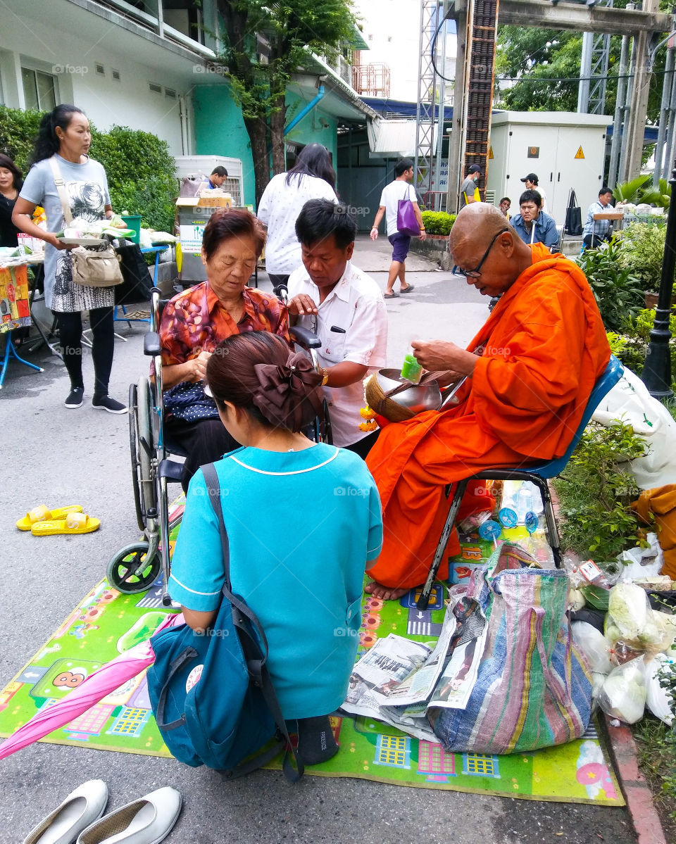 Thai culture , give alms to the monk at Rajvithi hospital.
editorial only.