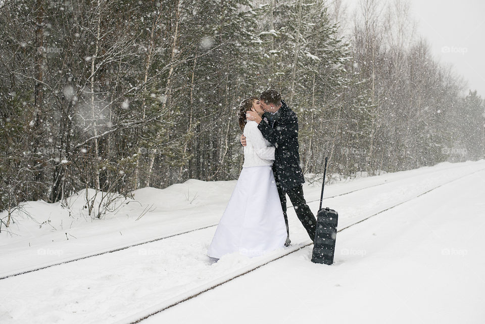 Young couple kissing during blizzard