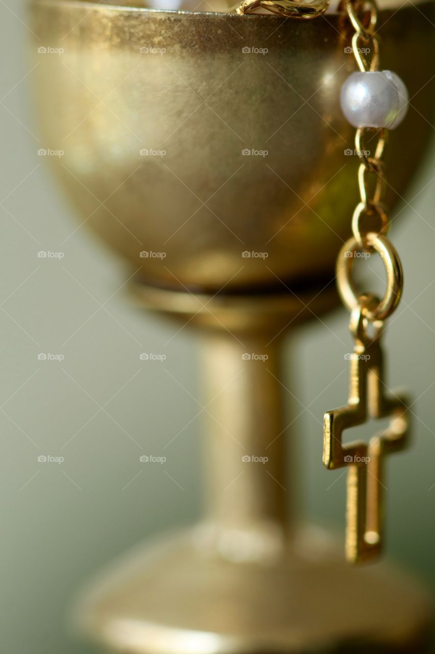 Goblet and golden crucifix