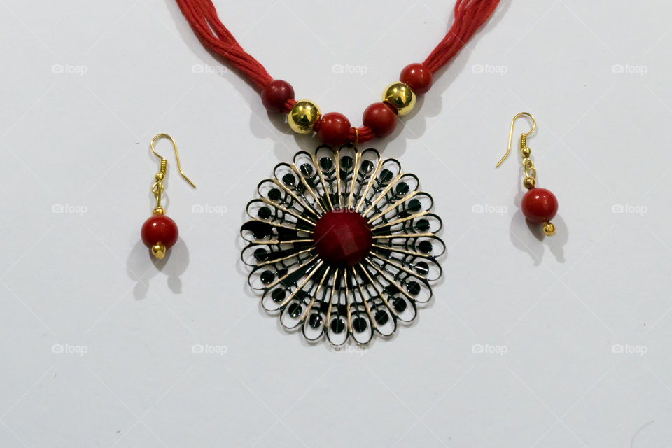 Homemade Indian Artificial designer Silk Thread Head Chain or Maang Tikka or Classic Bracelet with Earrings collection. Multi colored Fashion Jewelery or Easy Crafts on isolated white background.