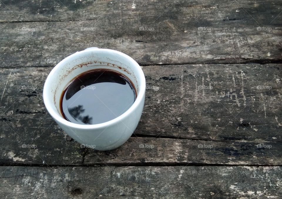 a cup of coffee on wooden table