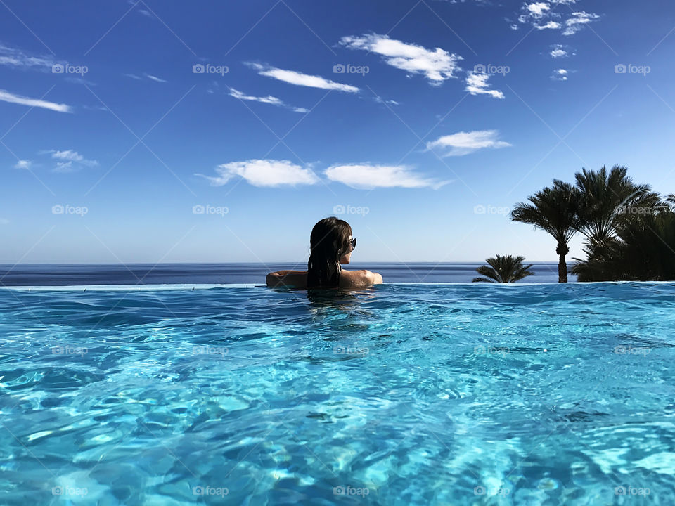 Summer tropical vacation at the swimming pool 