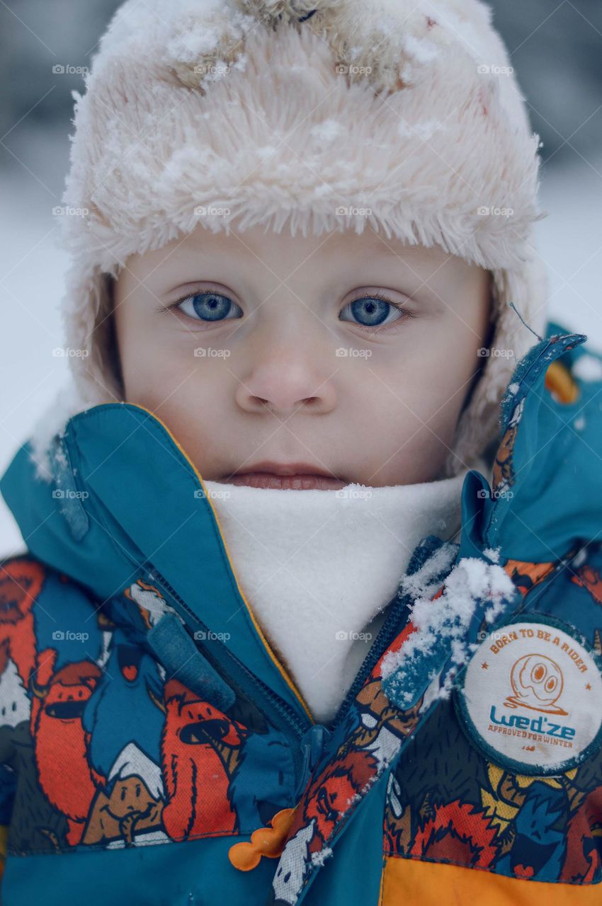 Little boy toddler with beautiful blue eyes.