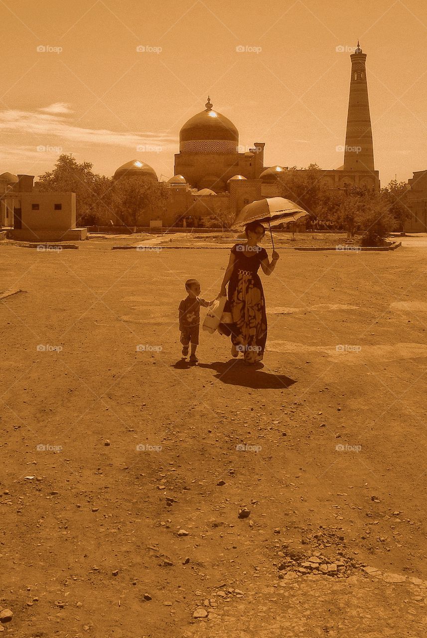 Hot day Motherhood. . This is Khiva, Uzbekistan. The very old place recognized by UNESCO as ancient memorial. There is uniq architecture.