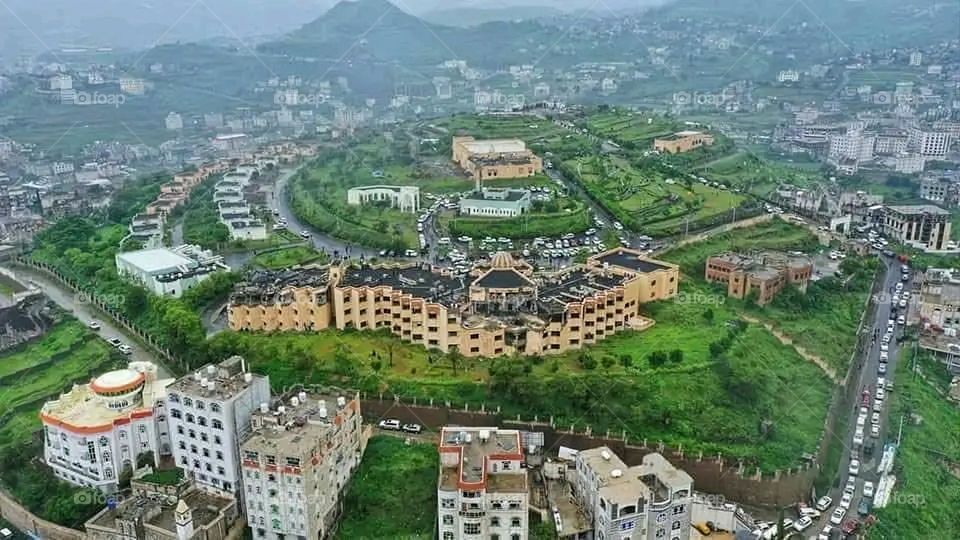 The image embodies a natural natural plate of the mountains of nature, where green agricultural stands are graded on the slopes as if they were lines of a poem, which fog harmoniously wrapped, and clouds hugged them in the mountain knife and the whis