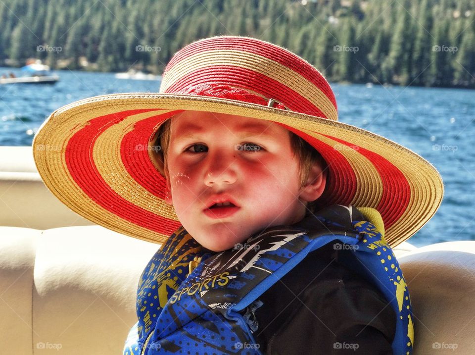 Sunburn Safety. Young Boy Wearing A Sunhat
