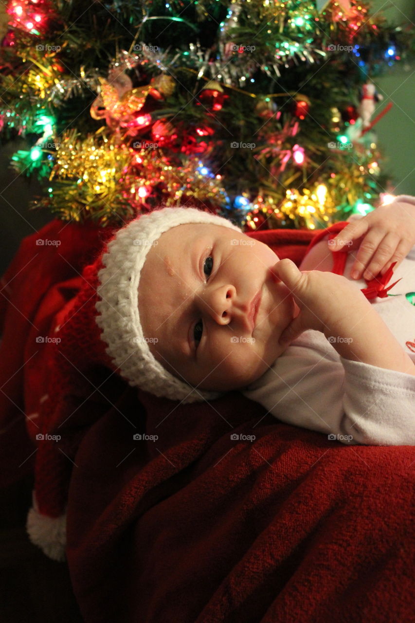babies first Christmas in a santa hat