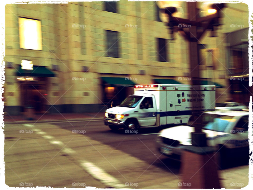 Ambulance speeding through a busy intersection.