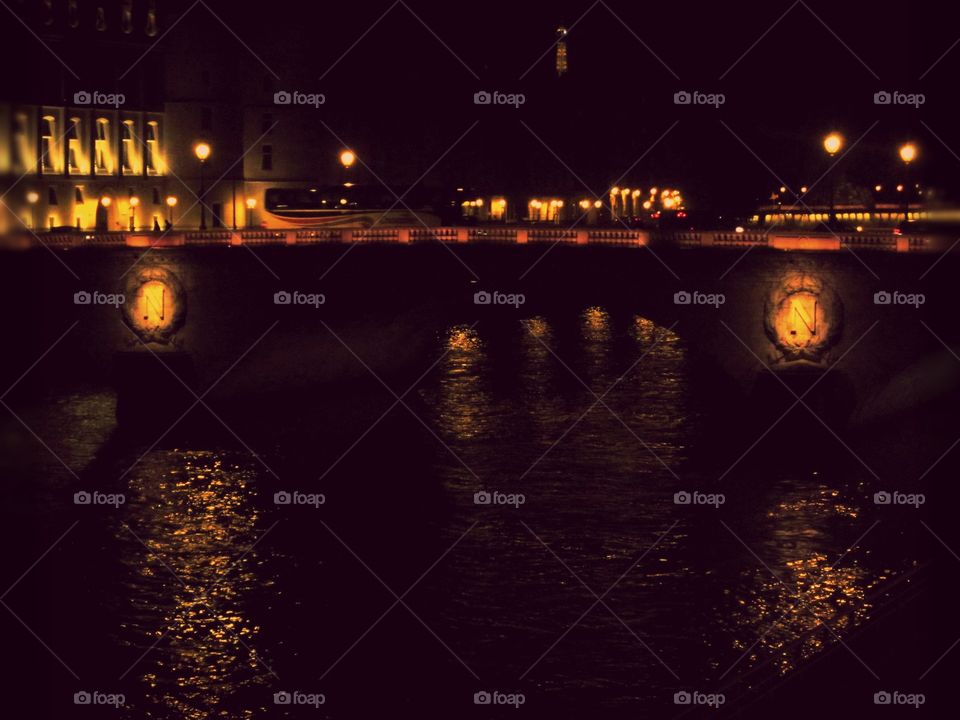 Napoleon Bridge at dusk in Paris with the Eiffel Tower in the distance.