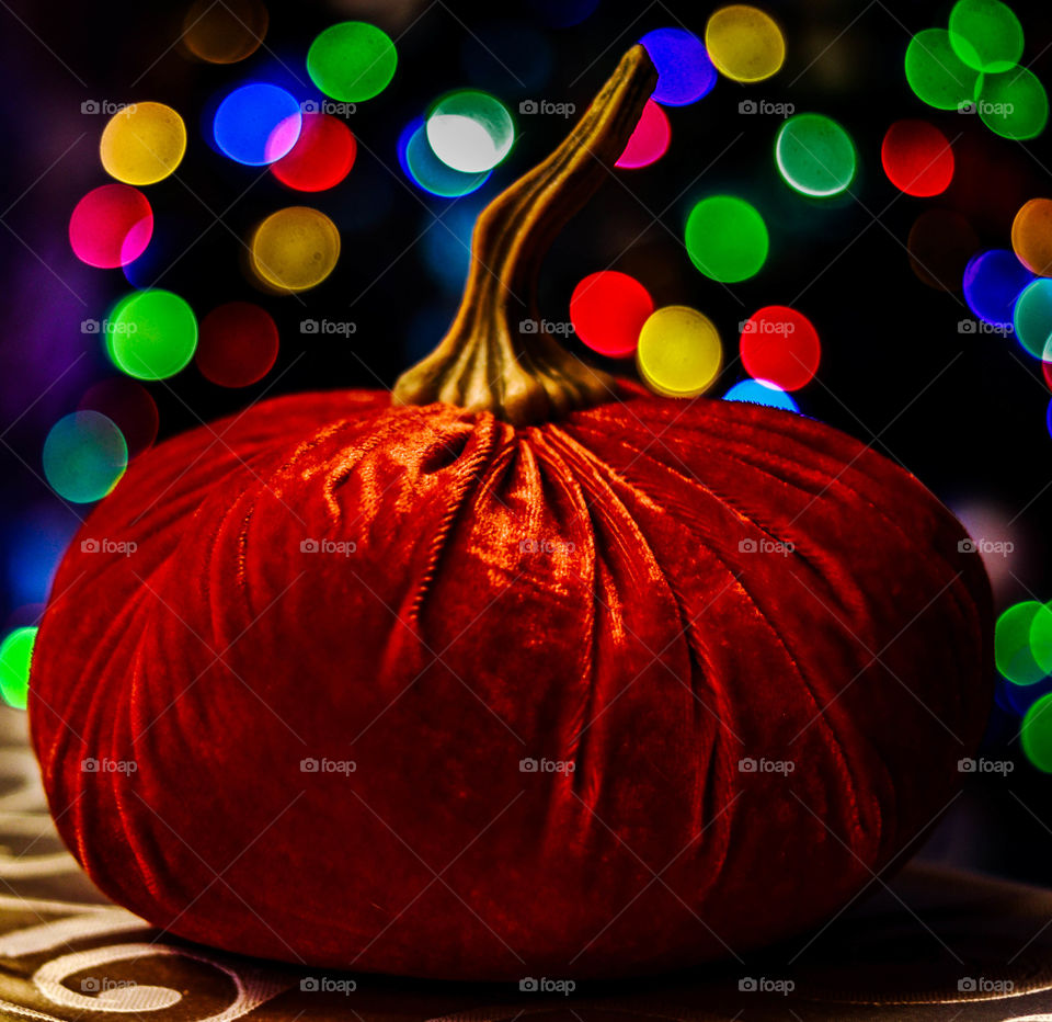 pumpkin with lights in the background