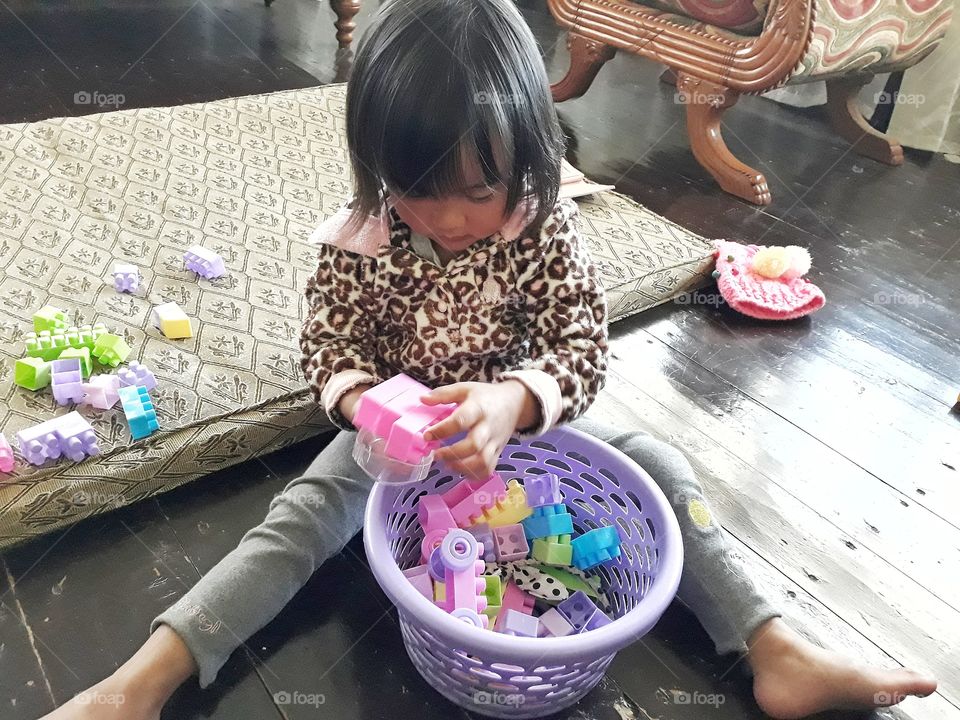 Girl child playing with her favourite building blocks...lego