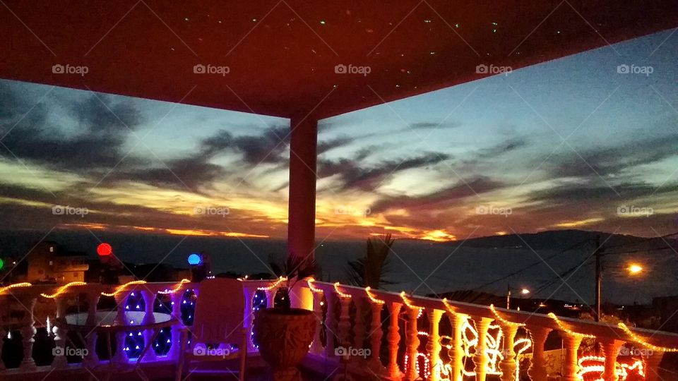 views of the sunset and the sea from the terrace decorated for christmas