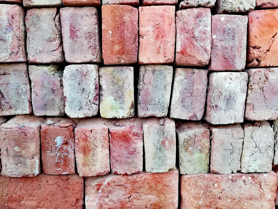 Bricks The foundation pf any building. The most essential part of construction.  A lot of bricks arranged in sequential manner.