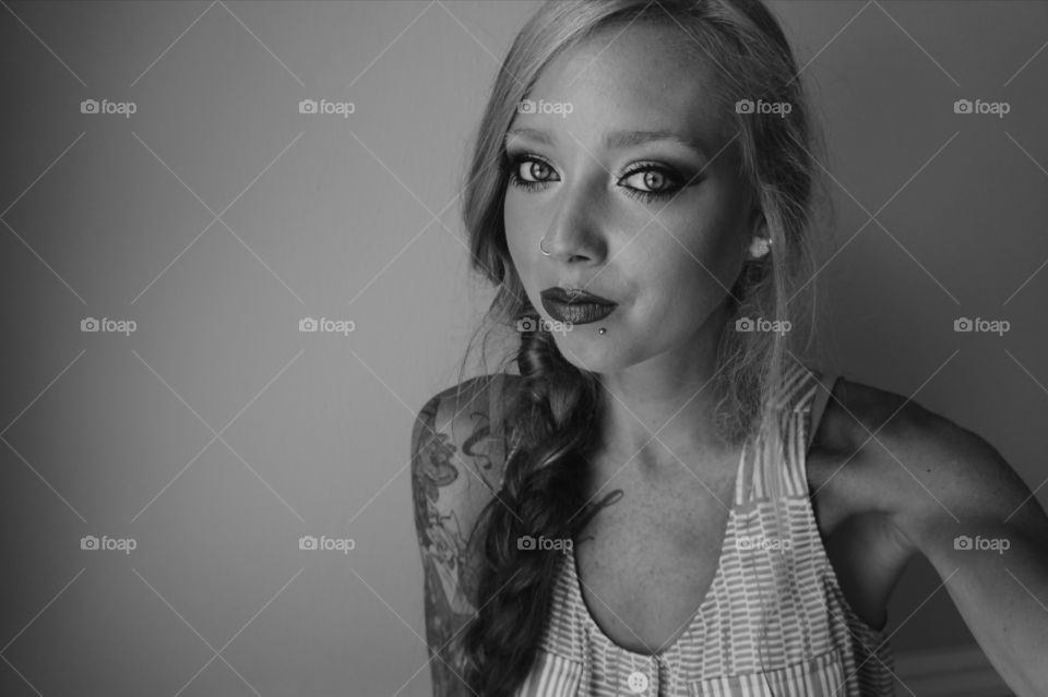 Pretty woman looking at camera against gray background