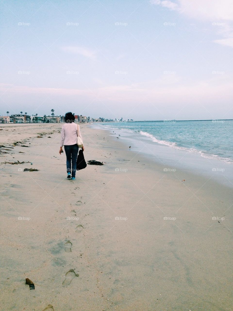 Woman Walking Along Coast