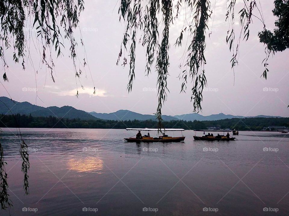 Boats on a river during sunset