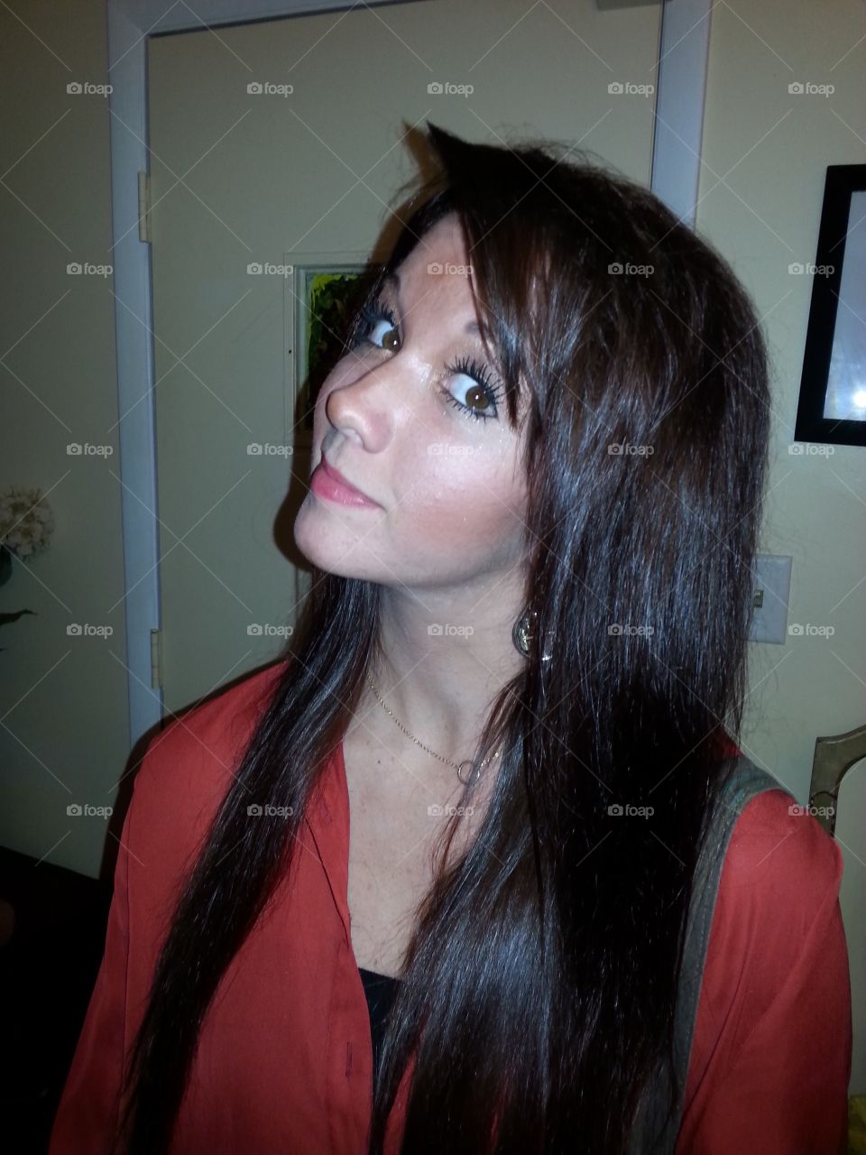 Young girl posing and looking at camera at home