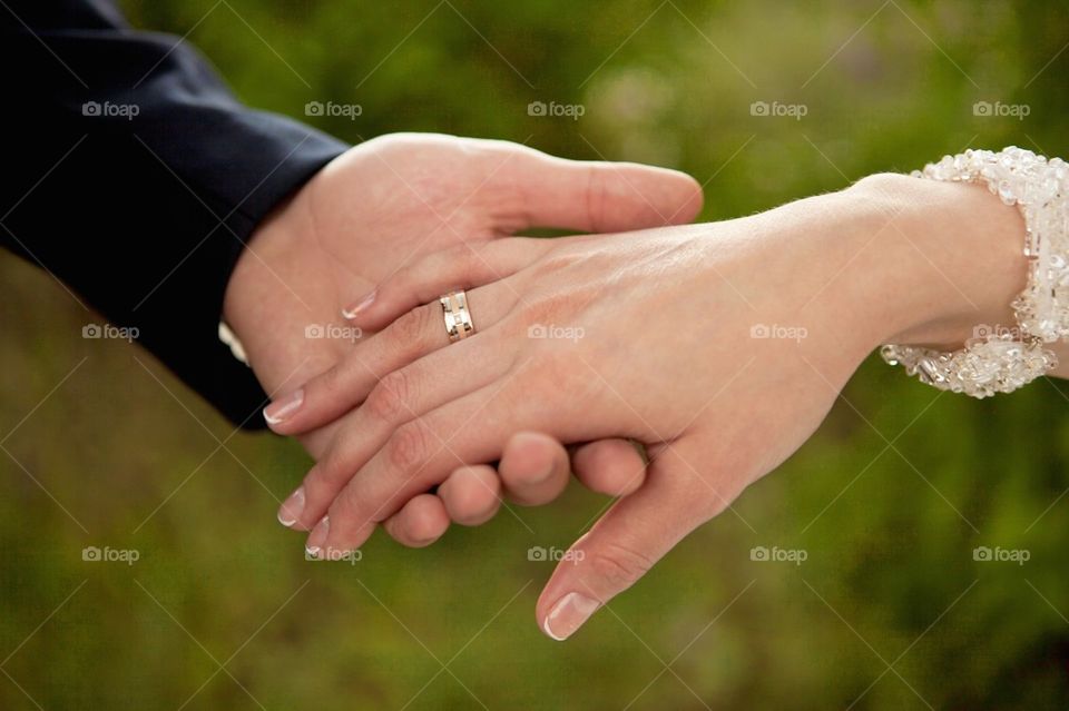 Close-up of couple holding hands