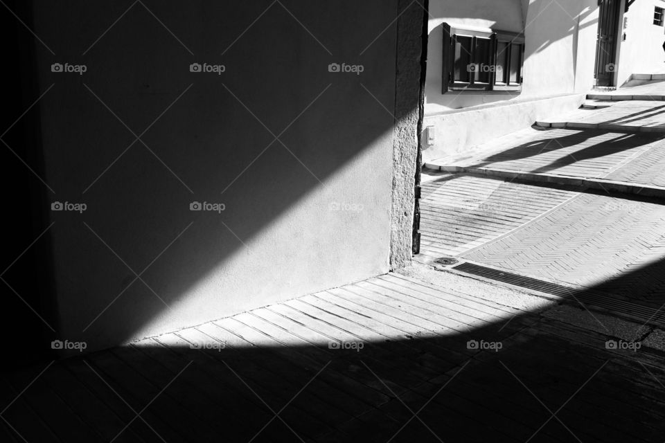 Sunlight shining through an alley creating shadows in Monaco city, Monaco