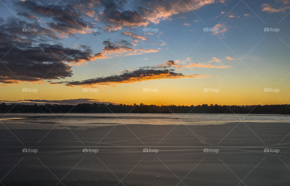 Sunset over a semi frozen lake.  The ice was thin and there was still a lot of moving water in the lake. 