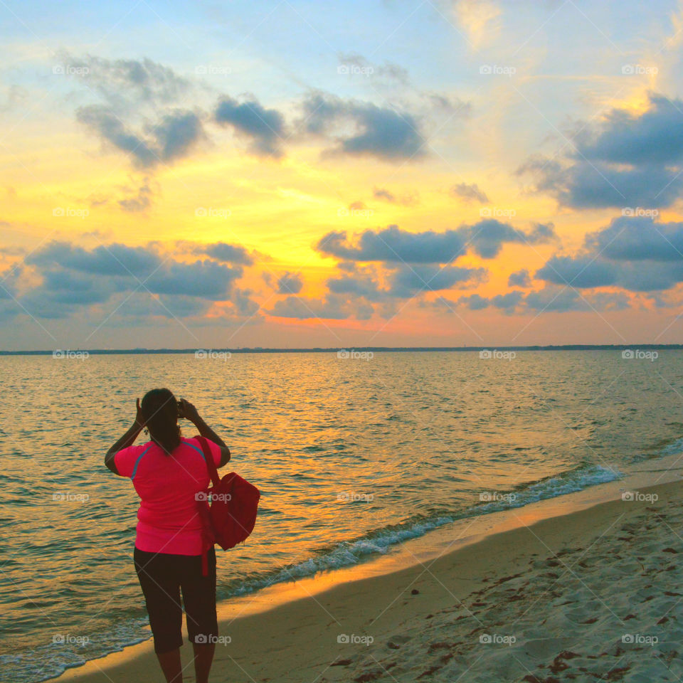 The sky was filled with the most brilliant orange complimented perfectly with hues of gold, yellow, red and crimson. An orange haze had casted over the water, reflecting off every wave.  Finally,the sun disappears along with the shine. I can only wait to see another magical moment of beauty and warmth! I can only wait for another sunset! Enjoy!