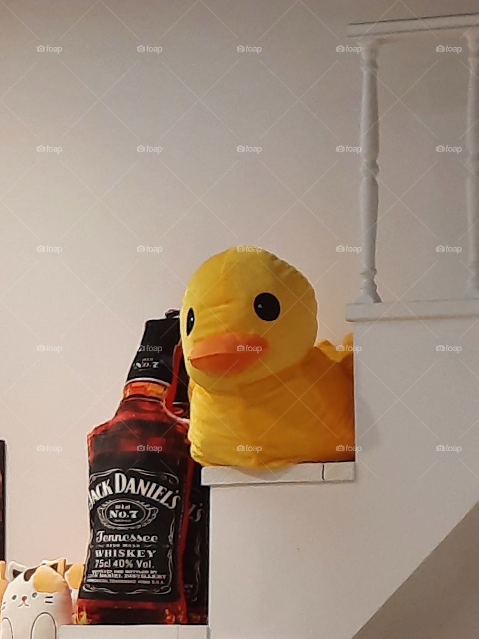 Giant plushy yellow duck with a bottle of Jack Daniels