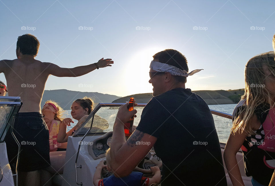 Group of friends enjoying at boat