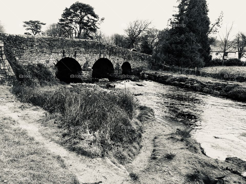 A black and white perspective from this iconic Dartmoor attraction that is Post Bridge in Devon.