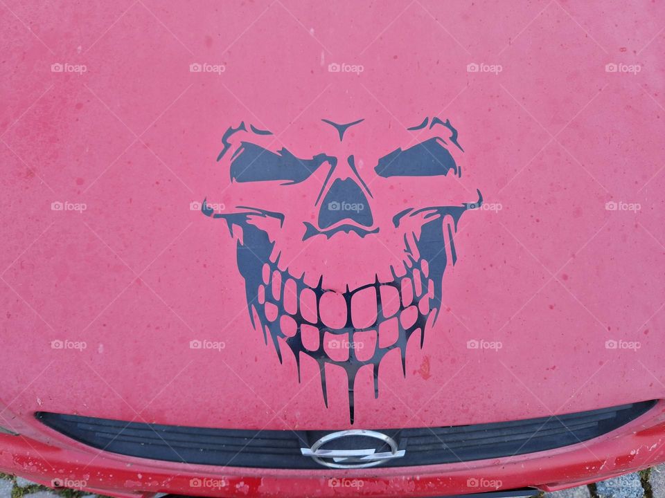 Skull on the red car Opel