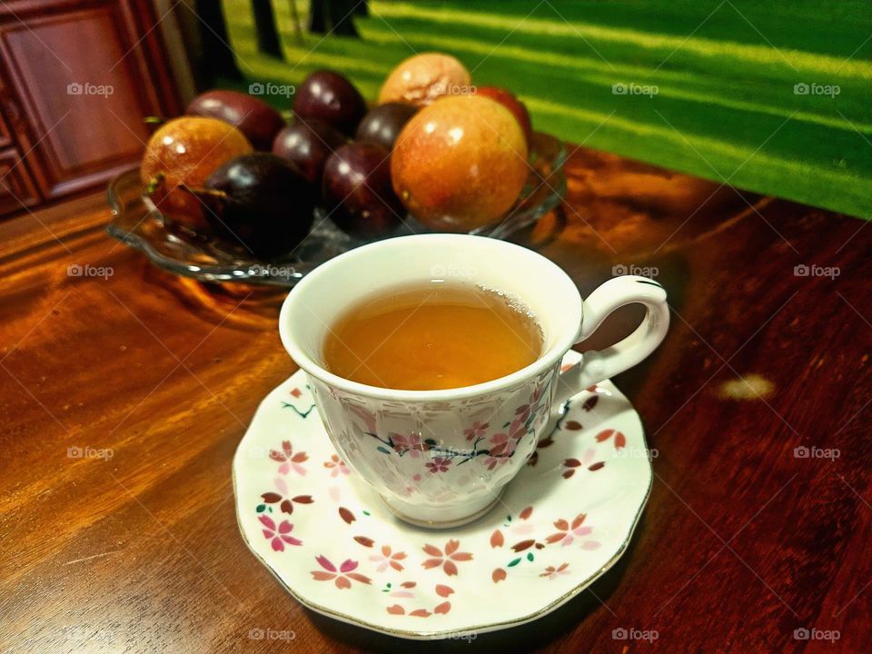 Black tea cup set with fruit background