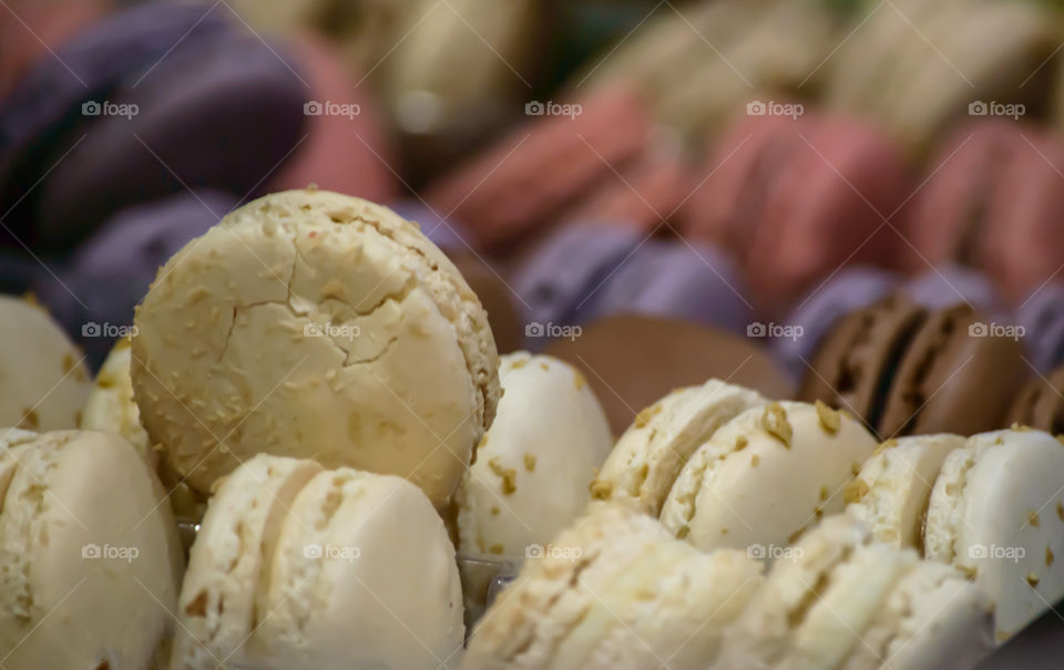 Coconut Macaron in a pile of sweet French cream filled cookies background selective focus with copy space 