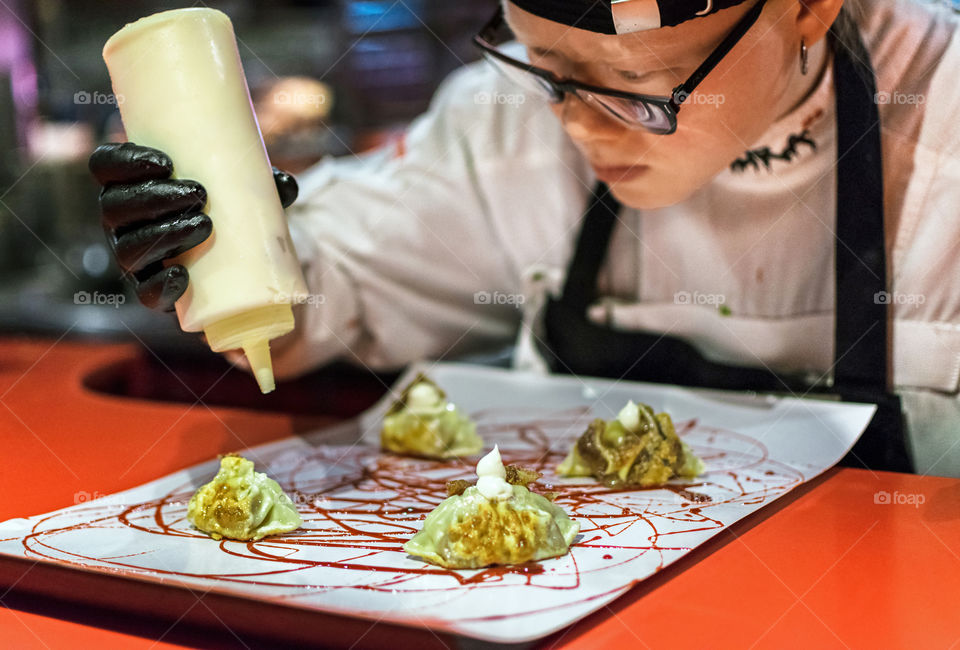 Chef finishing a dish display on a restaurant