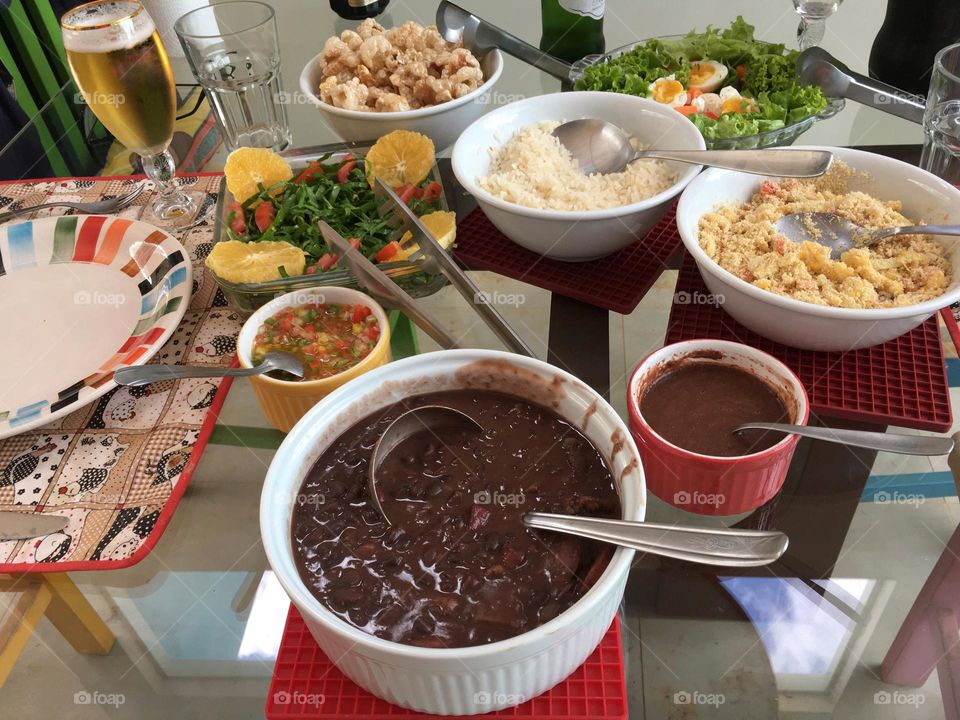 A complete Feijoada, the most famous Brazilian dish served with all the traditional complements