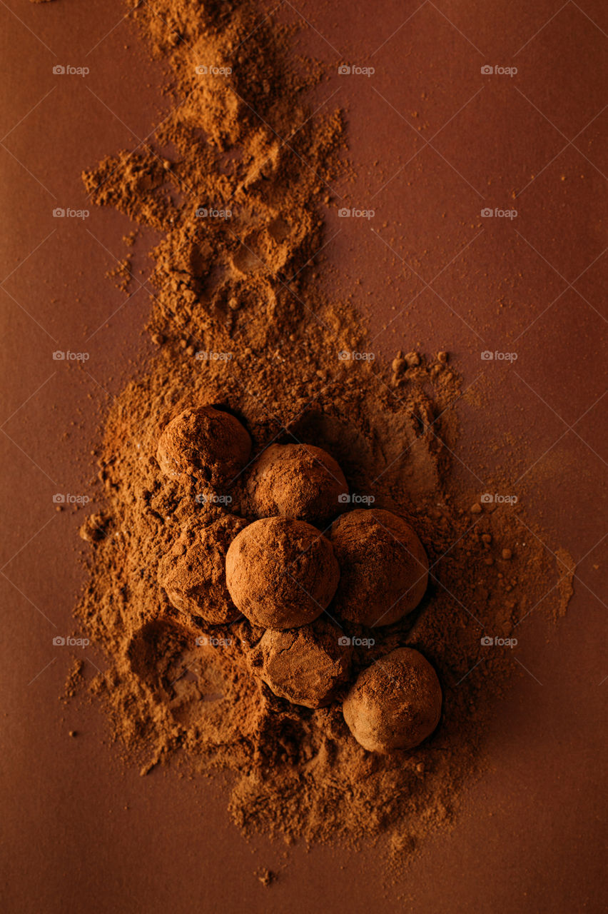 Dark brown chocolate cocoa balls in cocoa powder