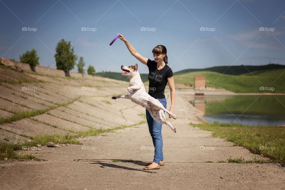 Woman giving training to her pet dog