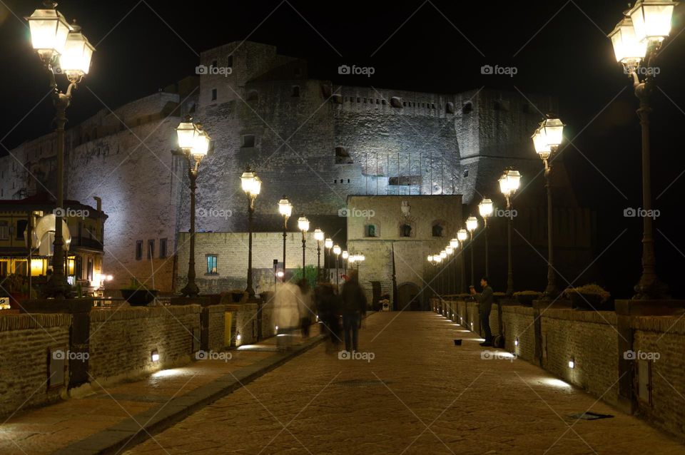 street with castel dell'ovo at night