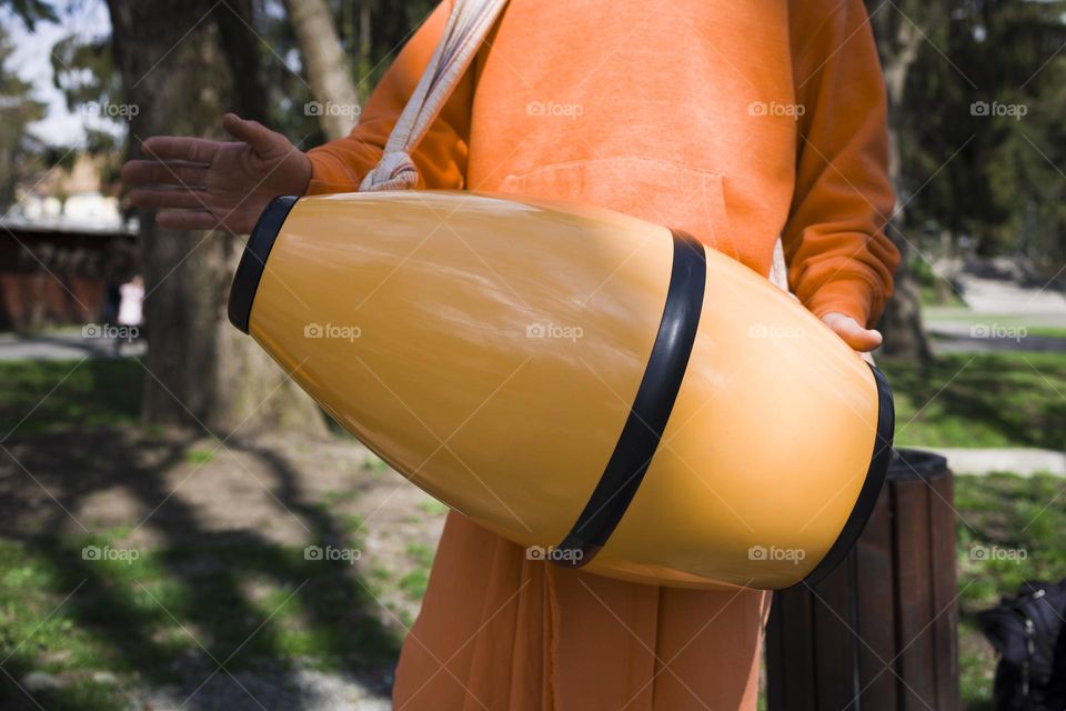 Hare Krishna orange drum close up view