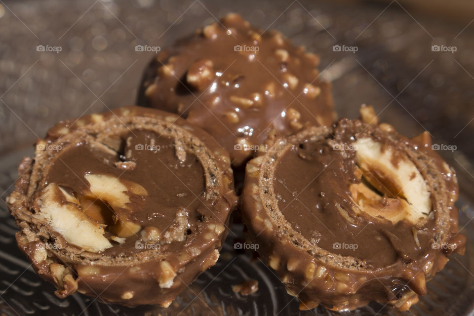 Round chocolate candy with nuts splitted into half 