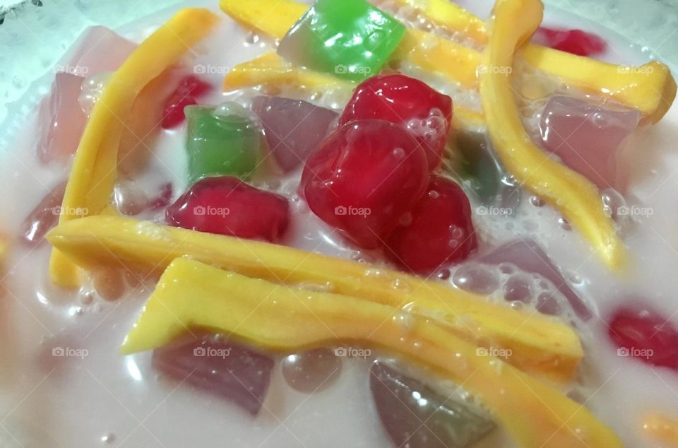 Thai Ruam Mit, typically contains (but not restricted to) Thapthim krop (cubes of water chestnut colored with red food coloring and soaked in sugar syrup), jackfruit, taro, sweet potato, corn and tapioca pearls in sweet coconut milk topped with ice!