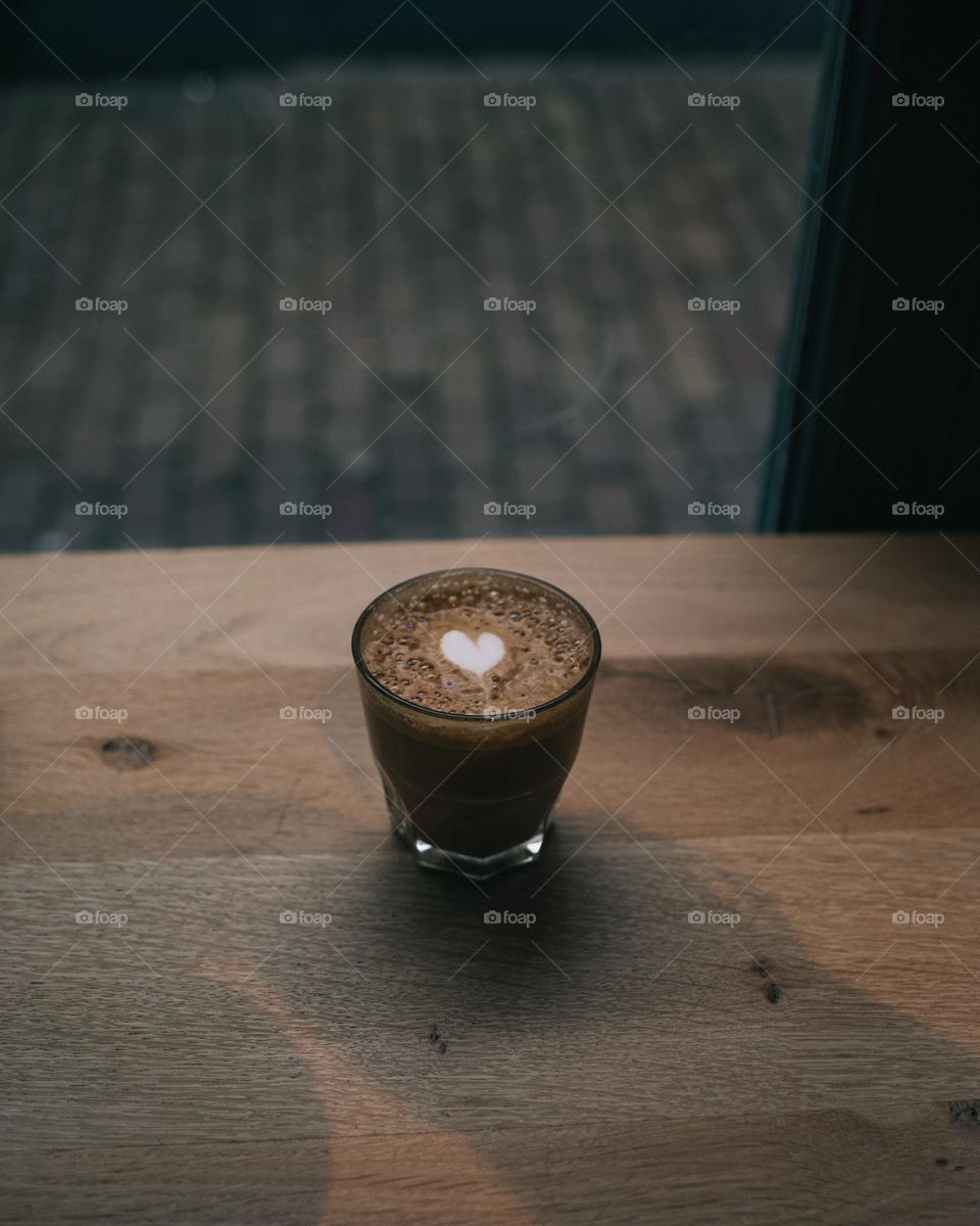 Coffee cup on the table with latte art hesrt