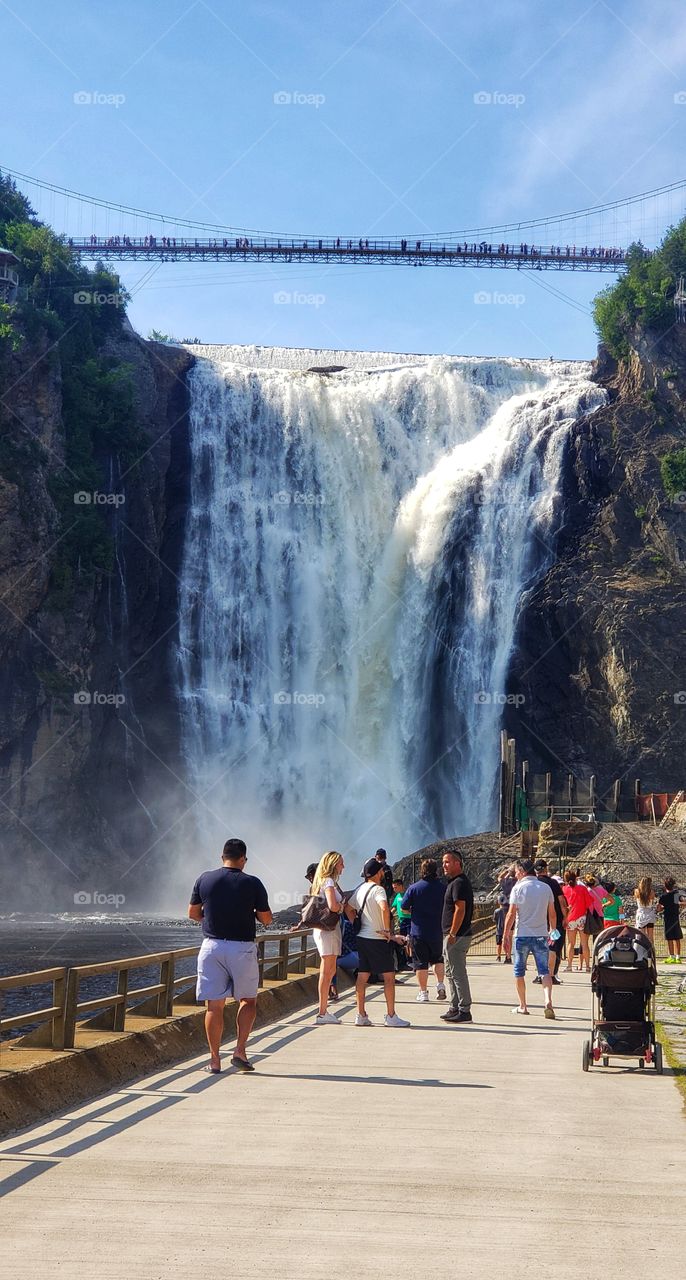 People in waterfall of summer