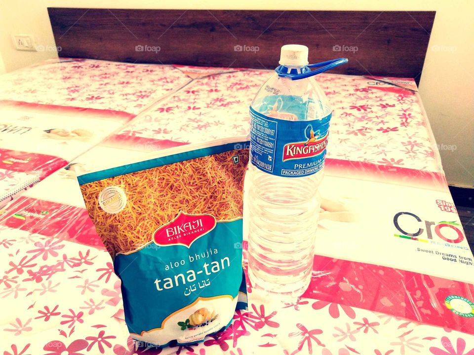 The bottle of water on the bed is kept saline