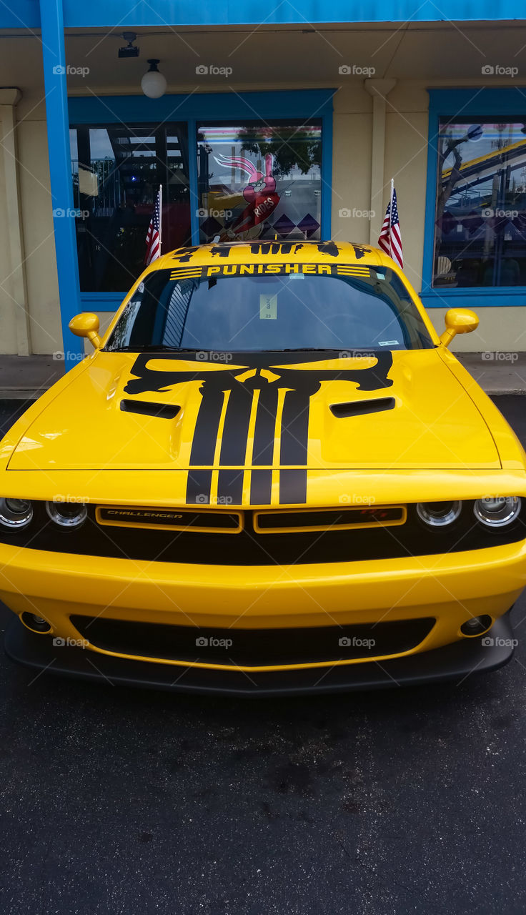 Dodge challenger decorated with "The Punisher " decals and the American flag