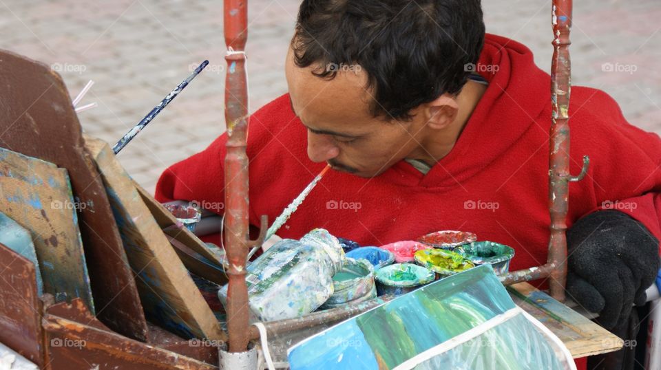 Painter holding brush in mouth