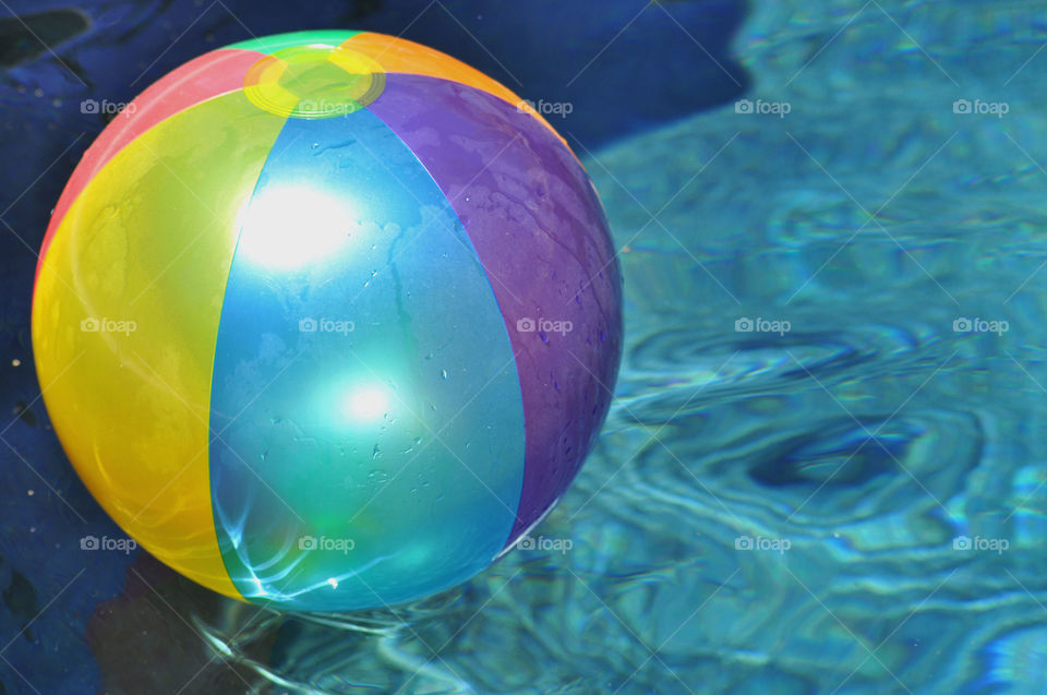 Foap mission shapes: a colorful beach ball floating in a swimming pool.