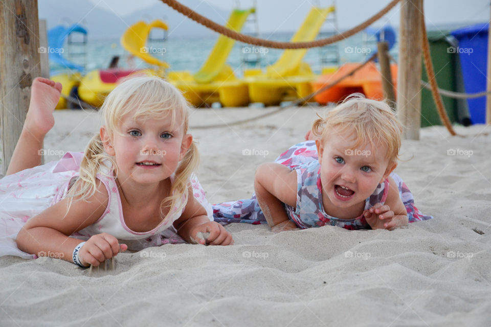Two sisters playing on the beach og Majorca, Spain.
