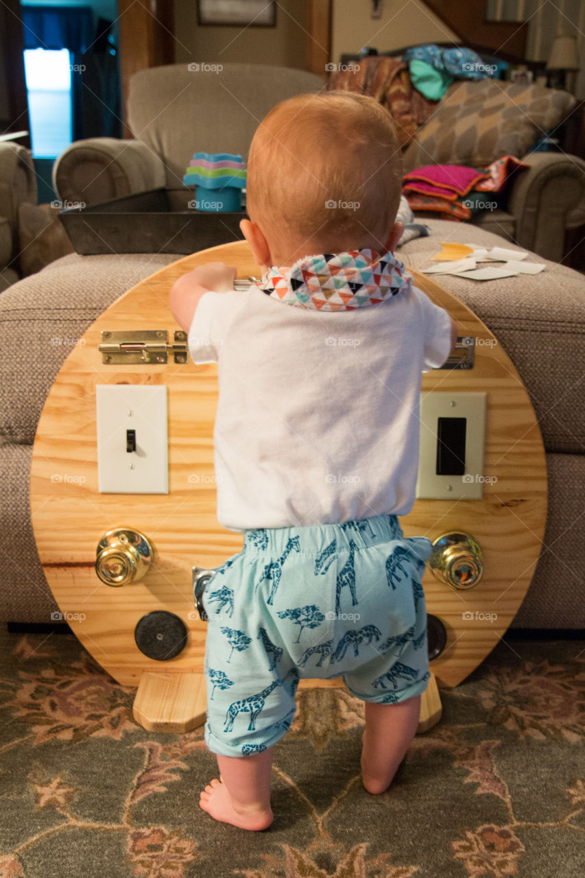 Playing with his activity board 