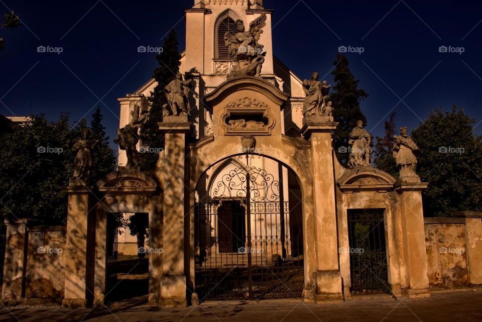 The gate that leads to a whole new world,a gate with ancient defenders on top of it.